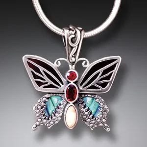 PAUA JEWELRY JEWELED BUTTERFLY NECKLACE WITH GARNET, BLACK MUSSEL, AND FOSSILIZED TUSK